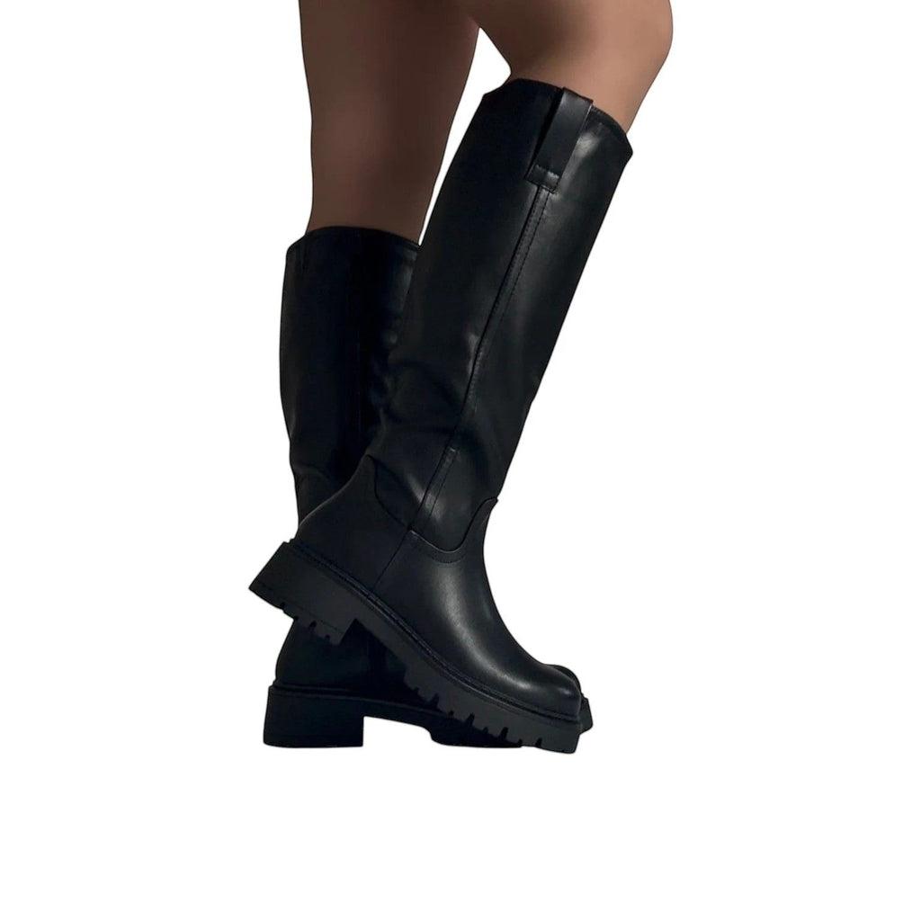 So and Ro black faux leather knee-high boots with chunky lug sole and refined fit, perfect for festivals.