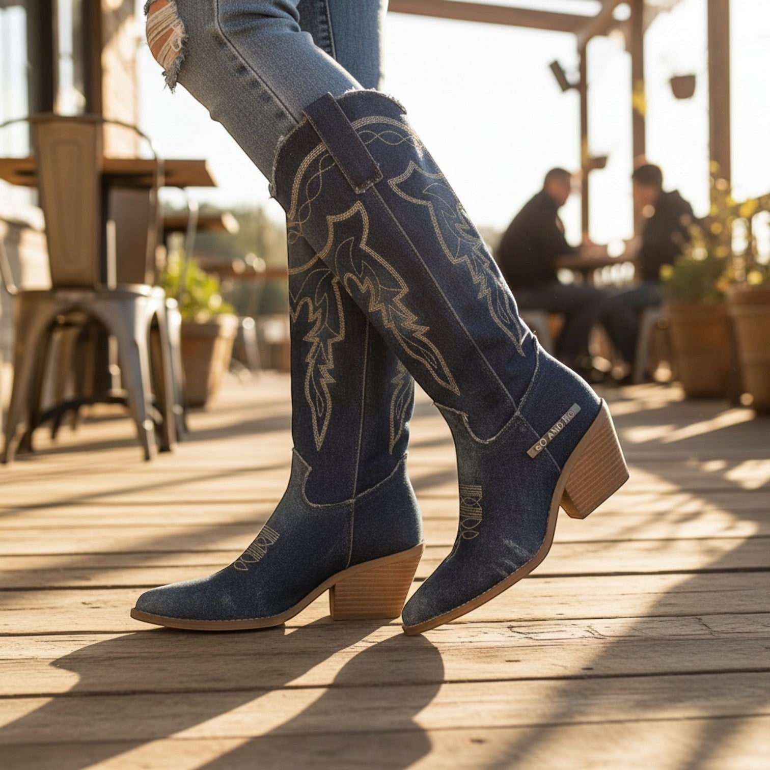 So and Ro blue denim western boots with intricate stitching and block heel, knee-high silhouette.