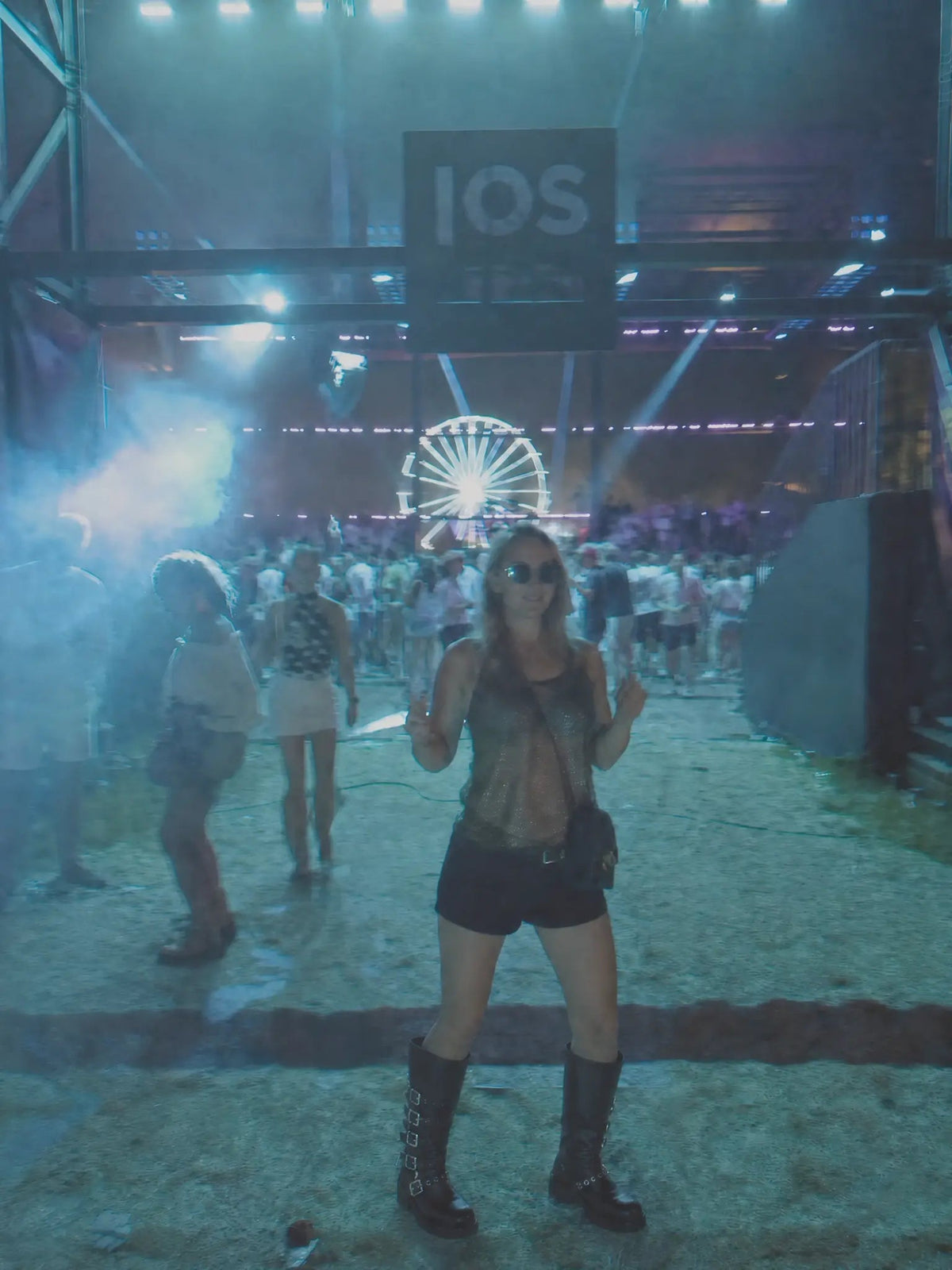 Woman wearing So and Ro - shoes and more - black faux leather biker boots with silver buckles at a festival