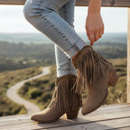 So and Ro taupe suede-look ankle boots with fringe detailing and studded trim, featuring a pointed toe and block heel.